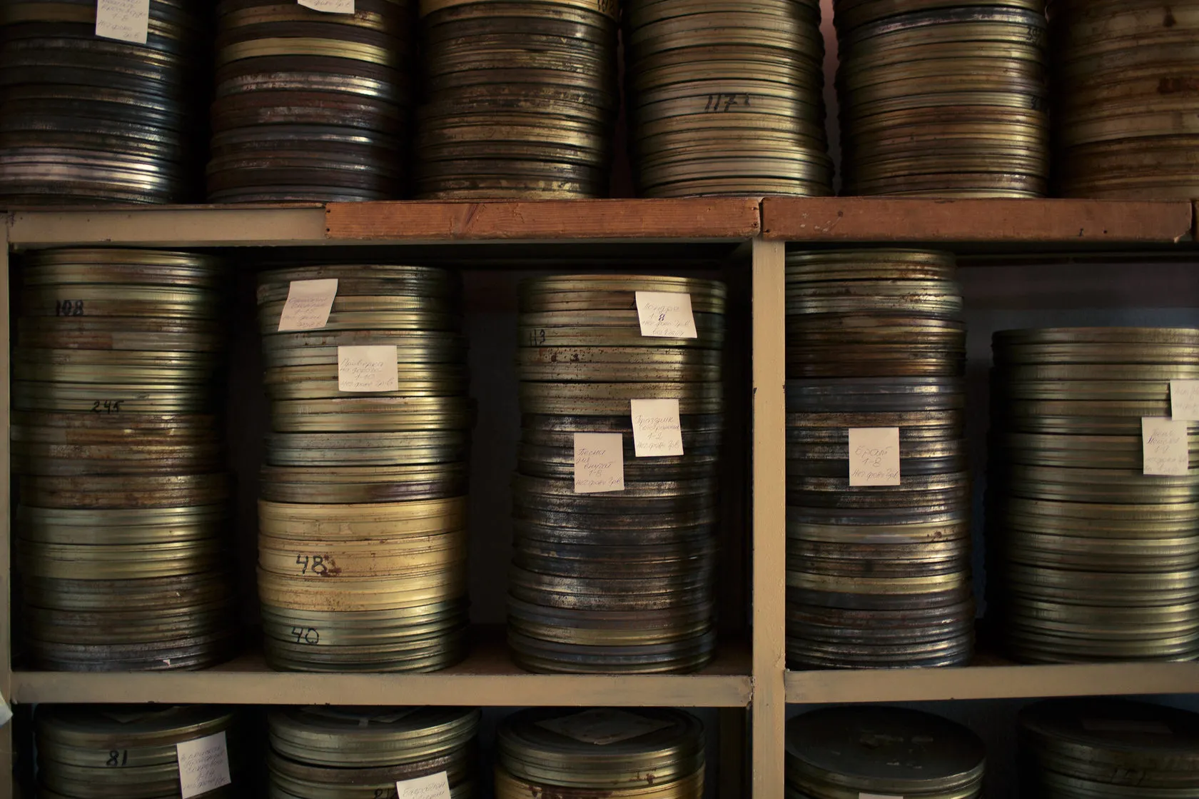 Film cans stacked on the shelves of the studio archive.