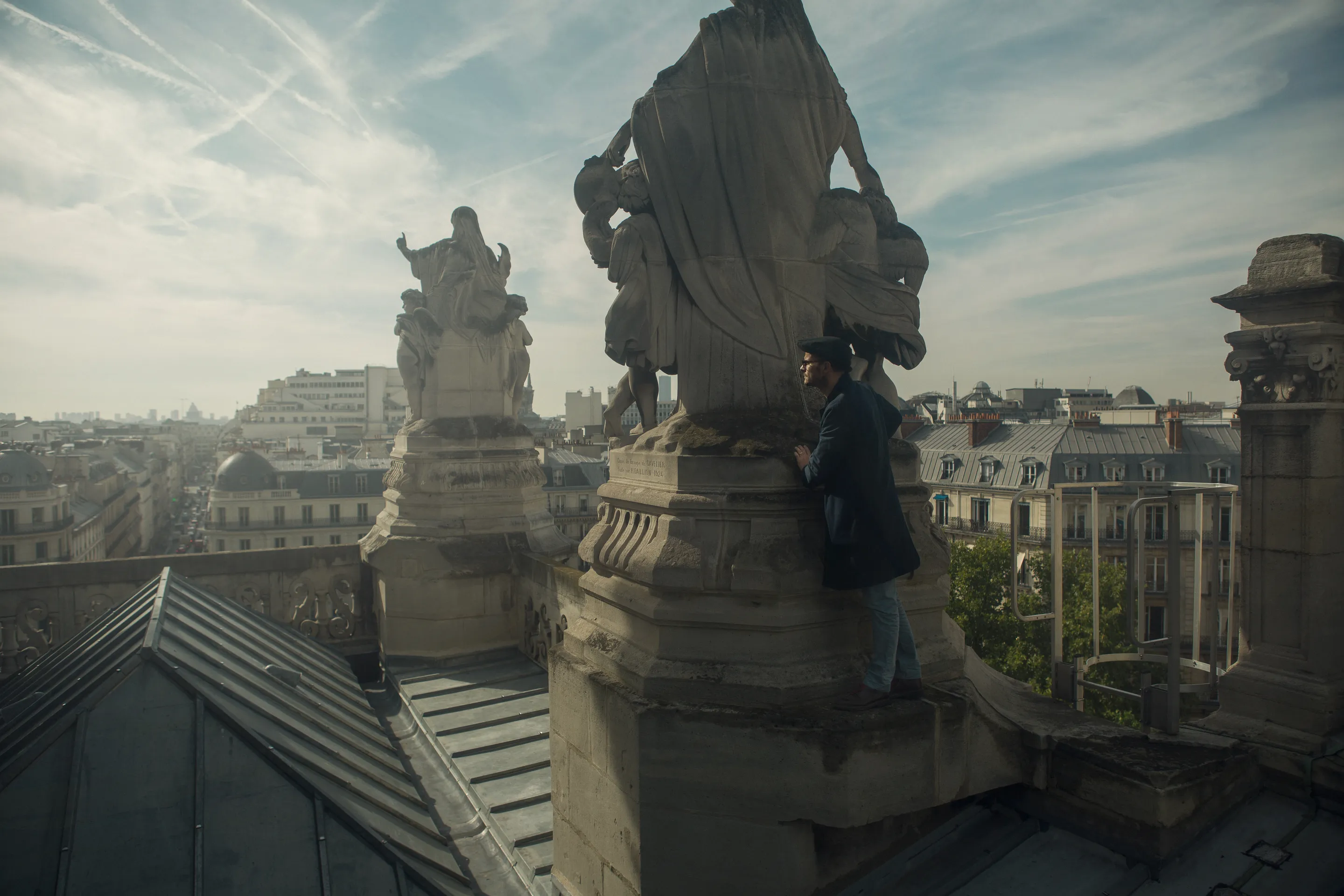 Laurent Clerc press portfolio by Andrei Kovalev: ornate stone statues line a Paris rooftop above the city.