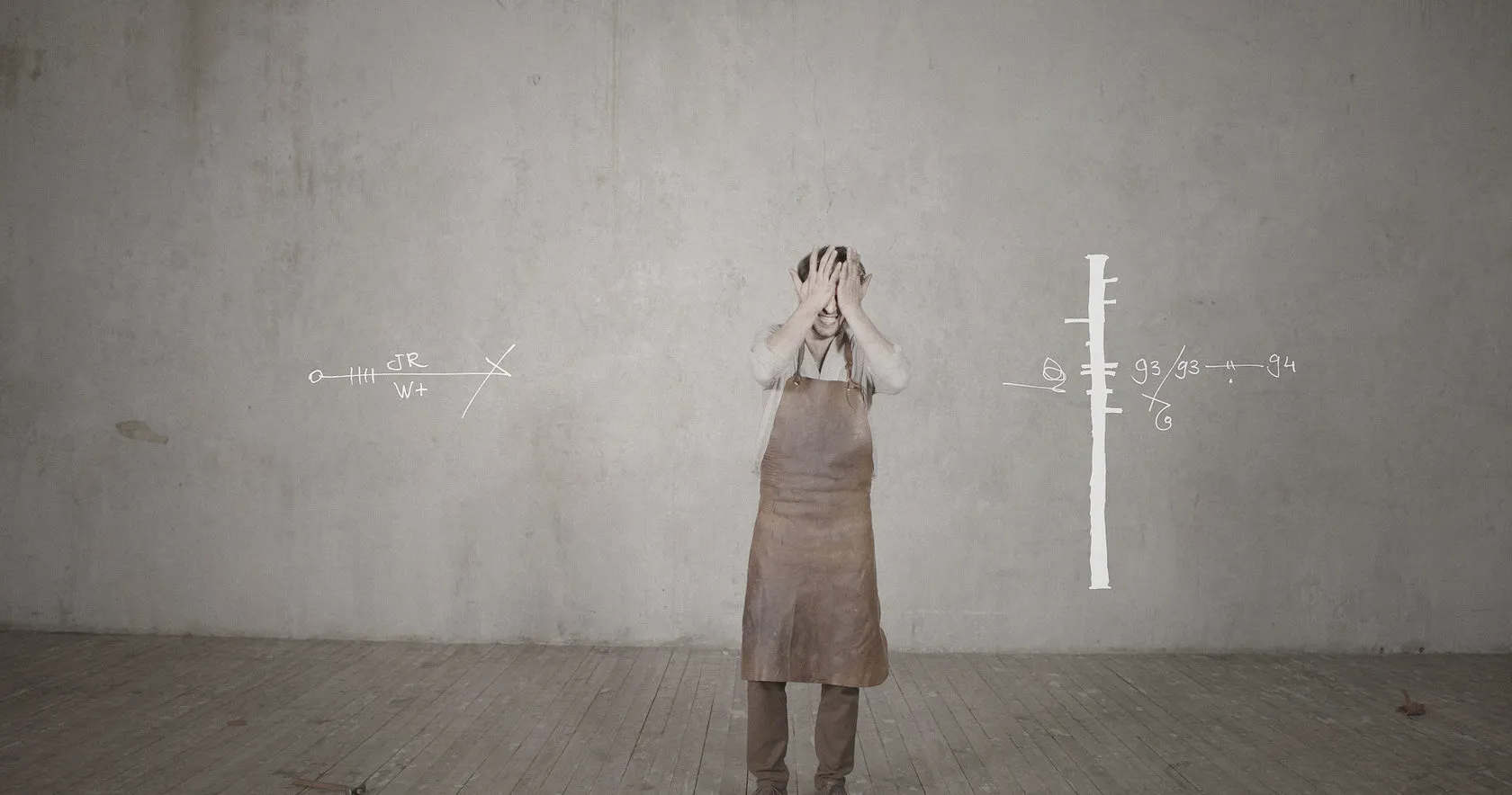 A man in a leather apron clutches his head beside a drawn measuring scale.